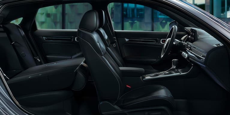 2026 Honda Civic Hatchback Touring Hybrid leather-trimmed seats with rear seat folded down (Compact Hatchback).
